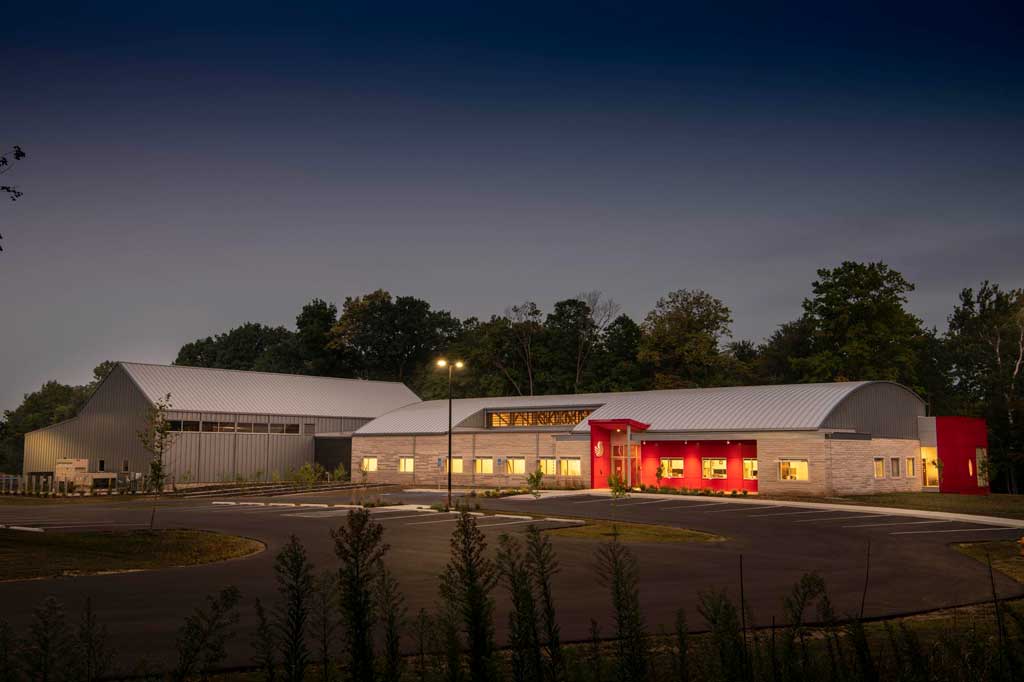 Evening view of the exterior buildings and spacious parking lot